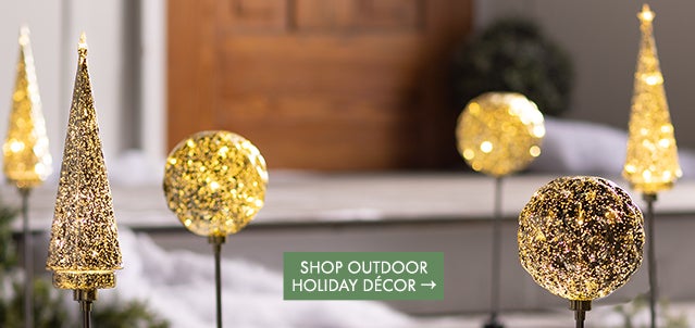 An image of sparkling lighted garden stakes leading to a front porch. Shop Outdoor Holiday Decorations