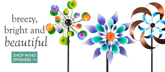 An assortment of brightly colored wind spinners on a white background. Breezy bright and beautiful. Shop Wind Spinners.
