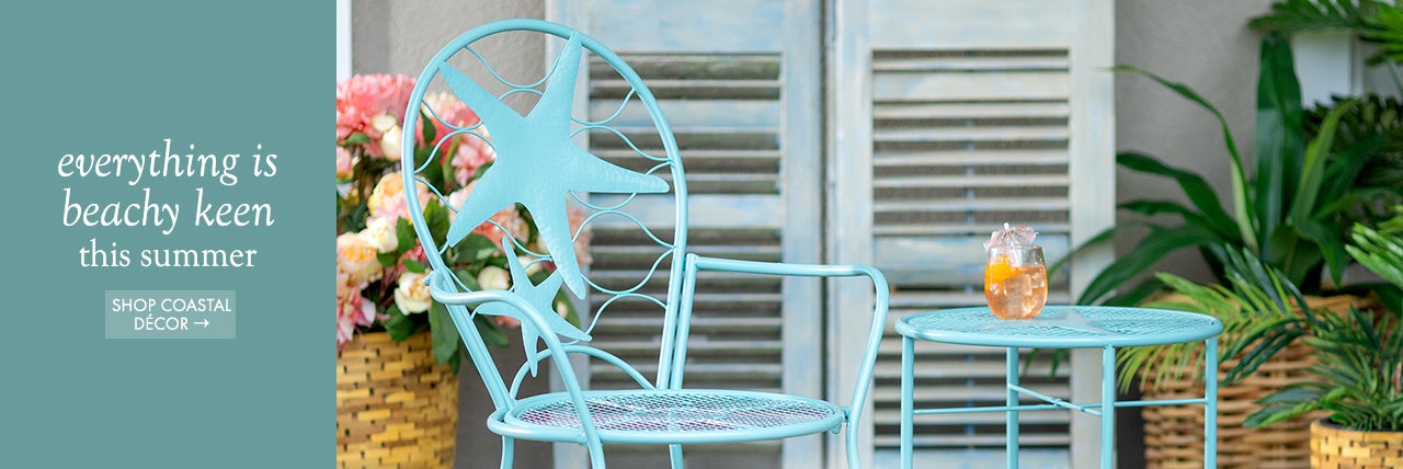 Lifestyle image of Starfish Table and Chair set on deck. everything is beachy keen this summer! SHOP COASTAL DECOR