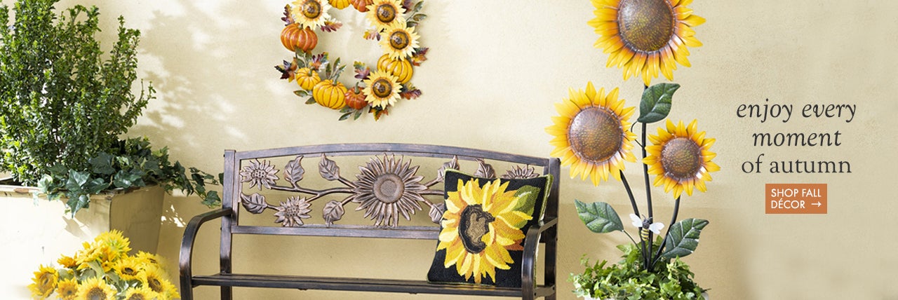 image of metal pumpkin sunflower wreath on wall, sunflower garden stakes and sunflower bench. enjoy every moment of autumn.  SHOP FALL DECOR