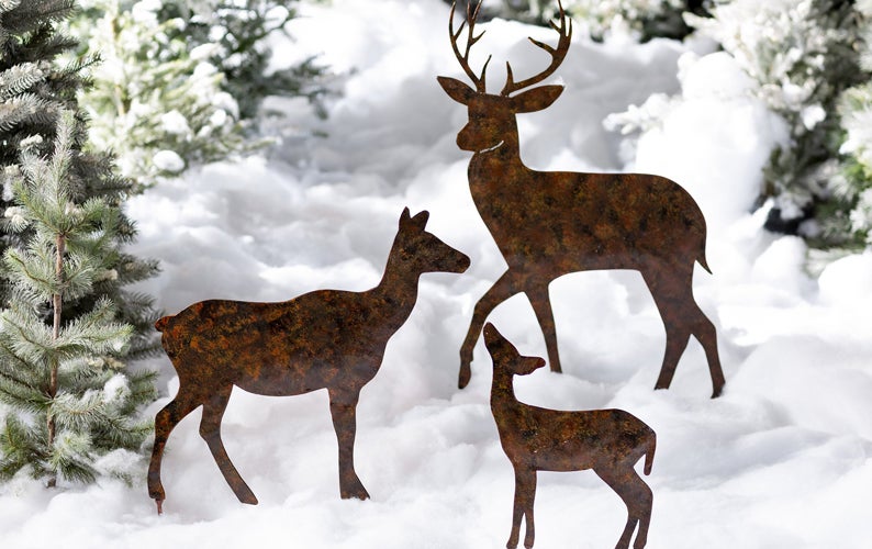 metal deer silhouette garden stakes in a snowy yard