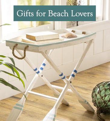 A nautical side table with oars as table legs. Shop Gifts for Beach Lovers