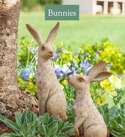 Image of Two Bunny Sculptures in garden. Bunnies
